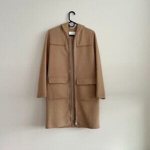 Sandro women's camel wool coat with hood zipped.